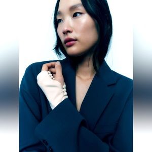 Satin effect fingerless gloves with self lined buttons.